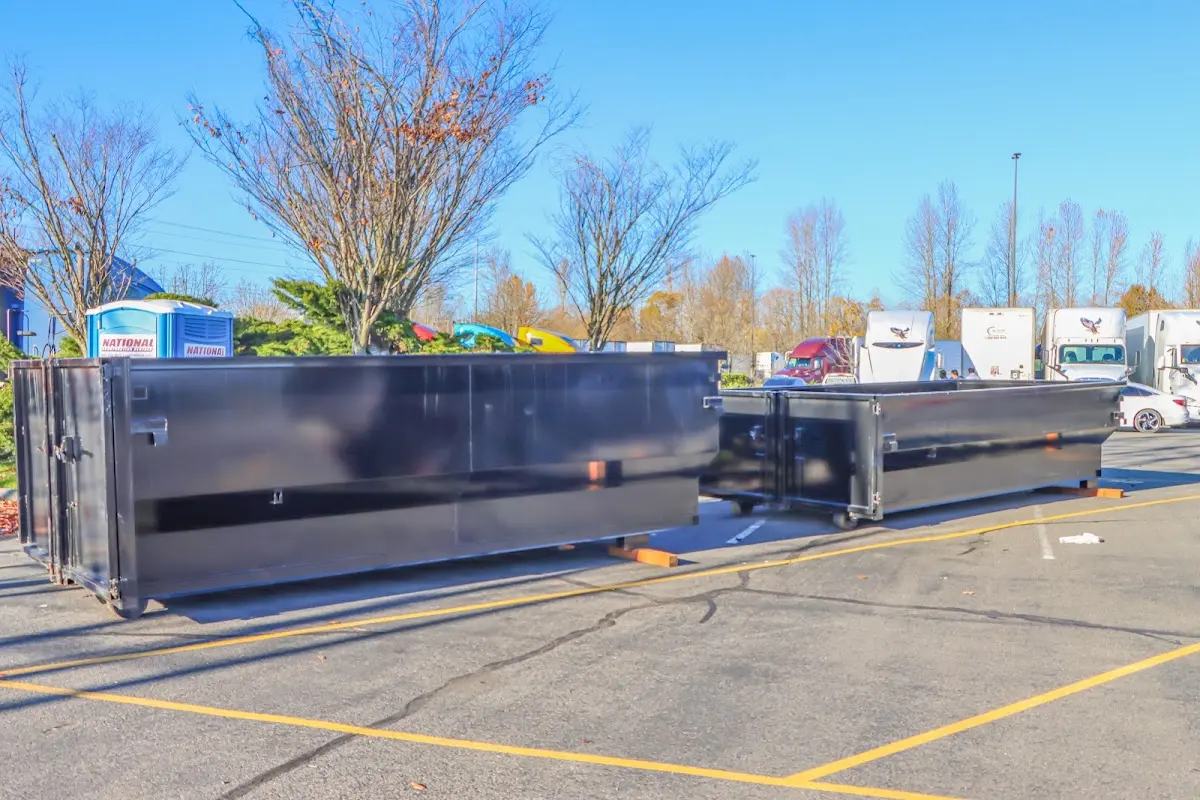 Professional dumpster rental service with roll-off container on residential driveway in Albany